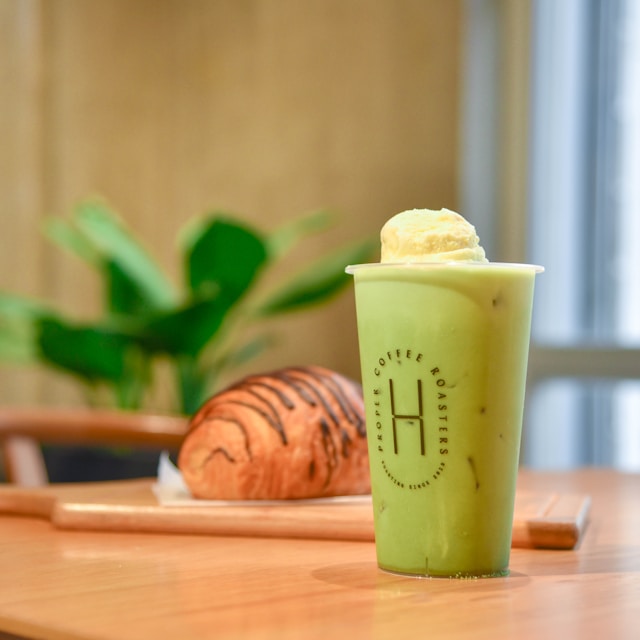 Matcha latte and croissant on display at Local Cafe